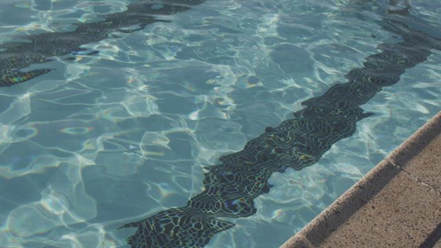Swimming slowly along the pool.