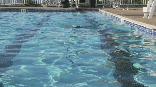 Swimming the length of a pool.