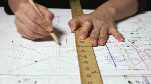 Architect drawing with a ruler.
