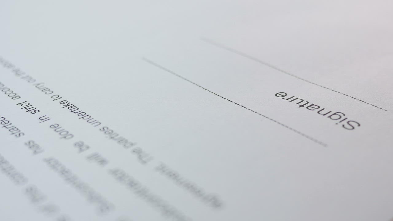Close up of a signature being written on a contract