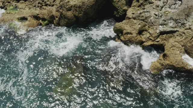 Clean waves breaking against the rocks.