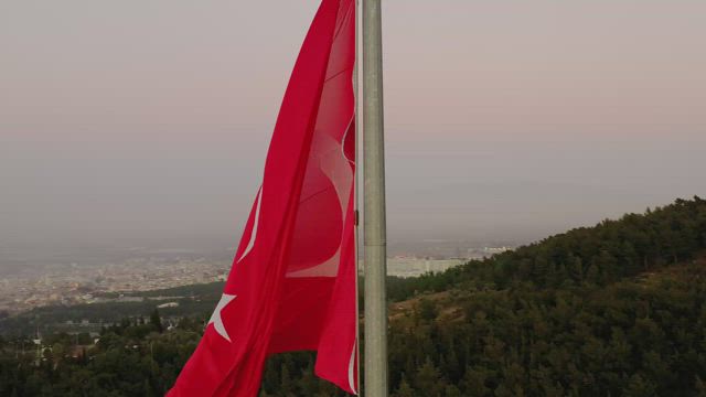 Moon behind a flag.