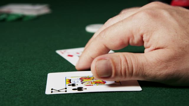Poker player moving their cards.