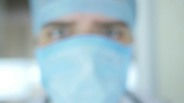 Doctor looking at the syringe.