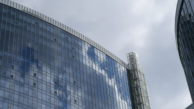 Glass buildings and cloudy sky.