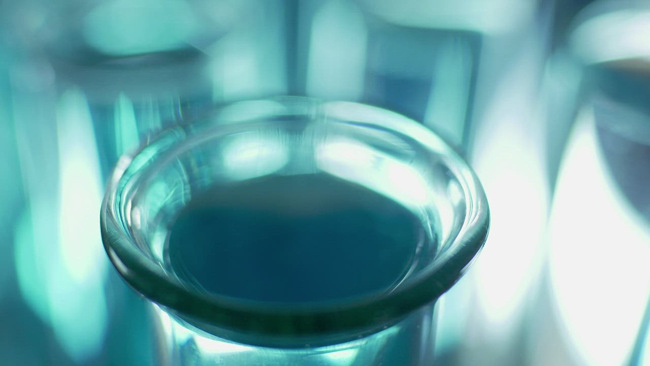 Dropping liquid into a lab tube close up - Free Stock Video