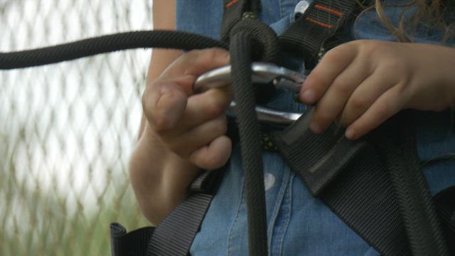Girl adjusting the harness .