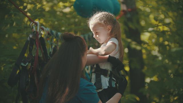 Woman preparing a girl for an adventure trip .