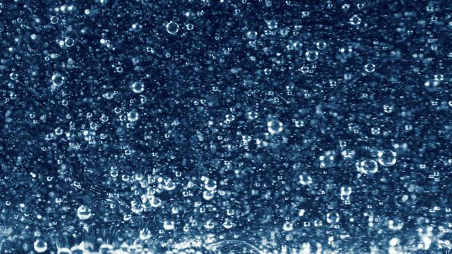 Bubbles in a blue oil pond.