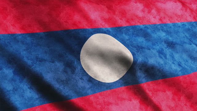 Laos flag with faded texture while waving.