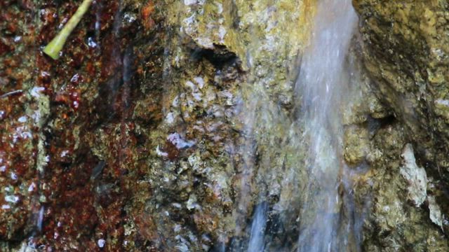 Tiny waterfall in a cracked rock.