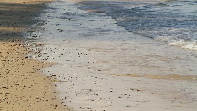 Shallow waves on a dirty beach.