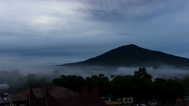 Mountain village covered in mist.