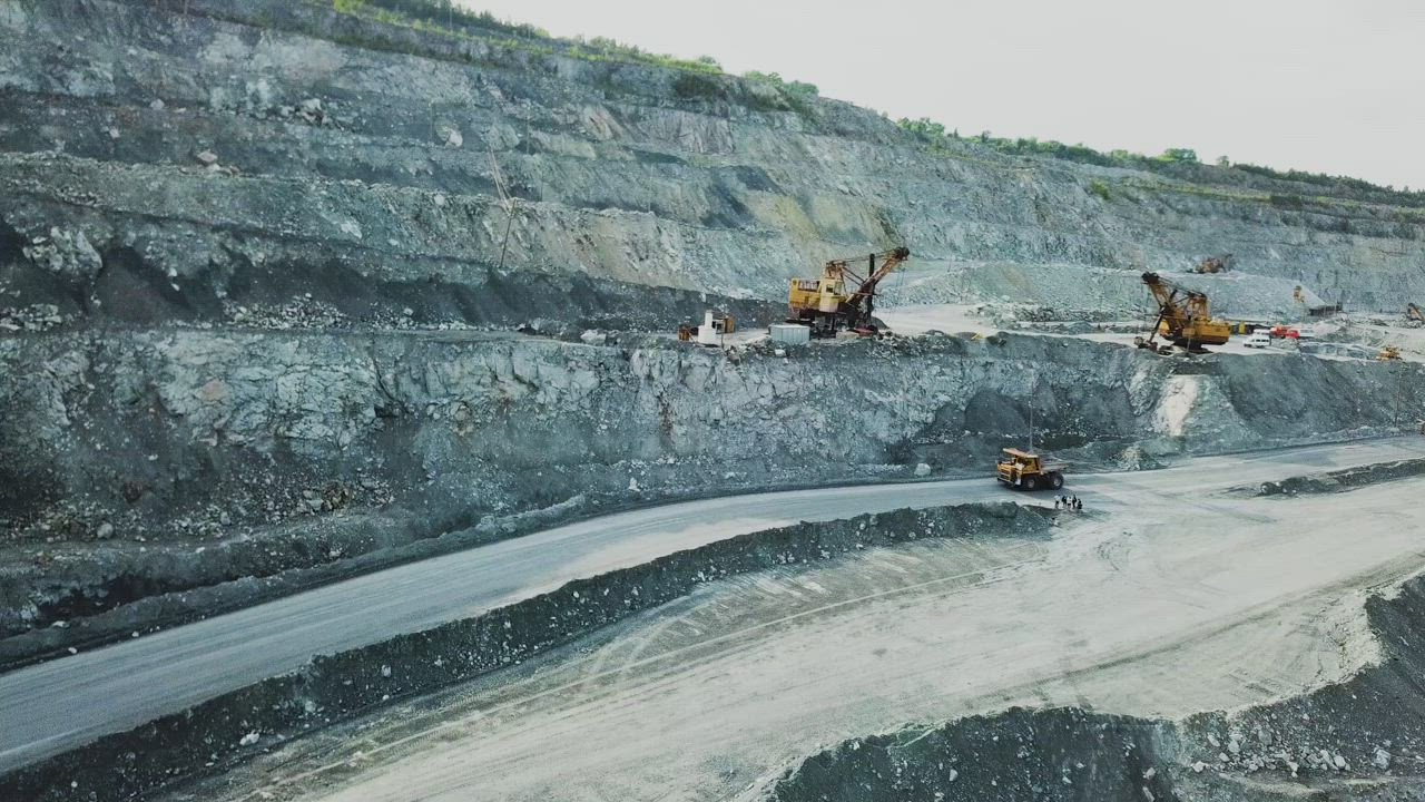 Truck driving down into a quarry - Free Stock Video