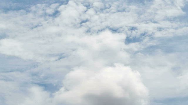 Thick white clouds above a city.