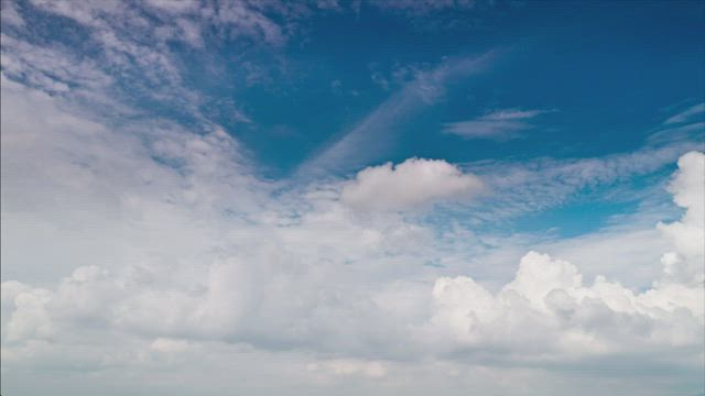 Layers of fluffy clouds against the blue sky.