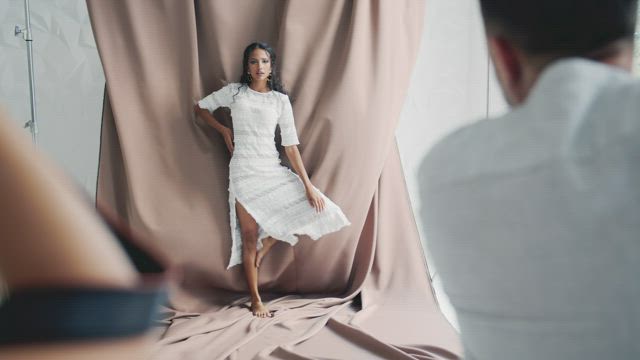 Photographers taking photos of a fashion model.