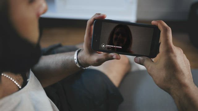 Man watching a video on his smartphone.