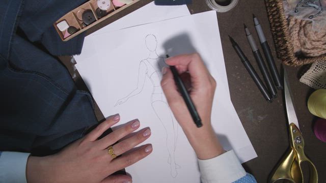 Designer drawing an outfit.
