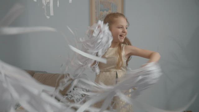 Dancing with paper confetti.