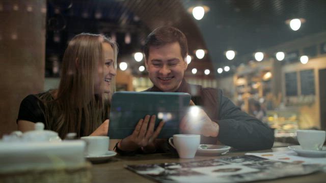 Browsing photos in a cafe.