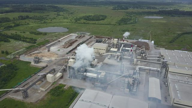 Flying over a large factory.
