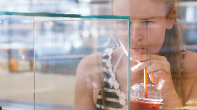 Woman looking in a Bakery window.
