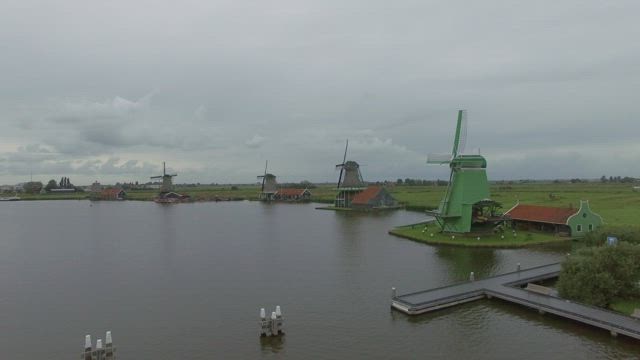 Windmills along a river.