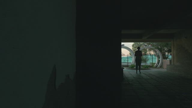 Woman using a jumping rope outside.