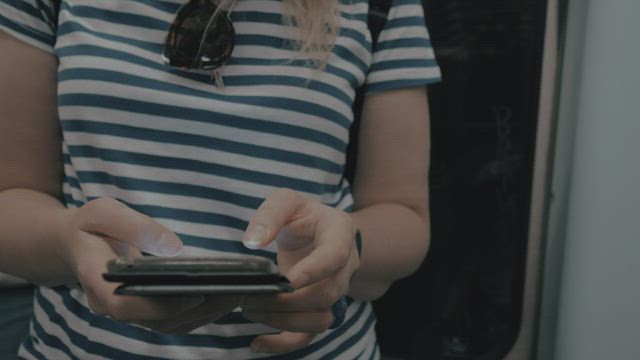 Checking messages on the subway.