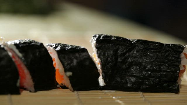Slicing up a roll of Sushi.