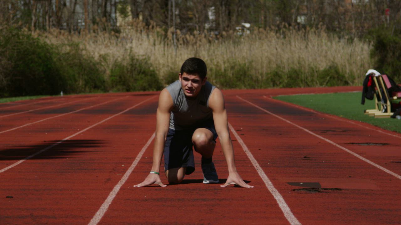 Man running down a track - Free Stock Video
