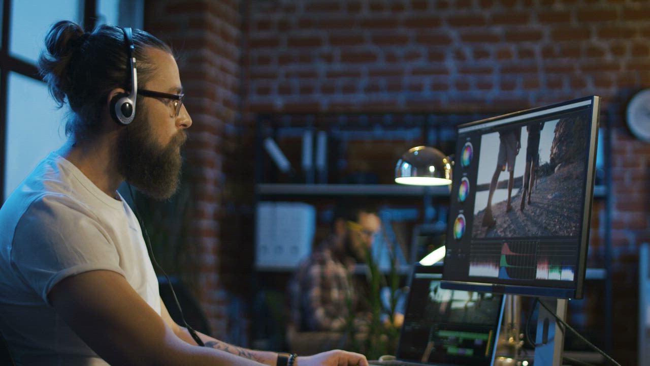 Bearded man working on video editing - Free Stock Video