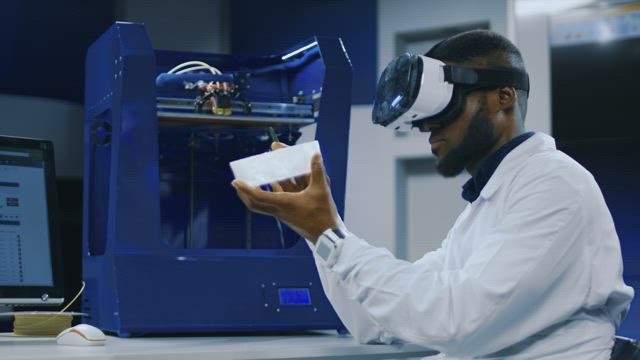 Scientist working with VR glasses and 3D printer.
