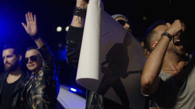 Musicians giving autographs to fans.
