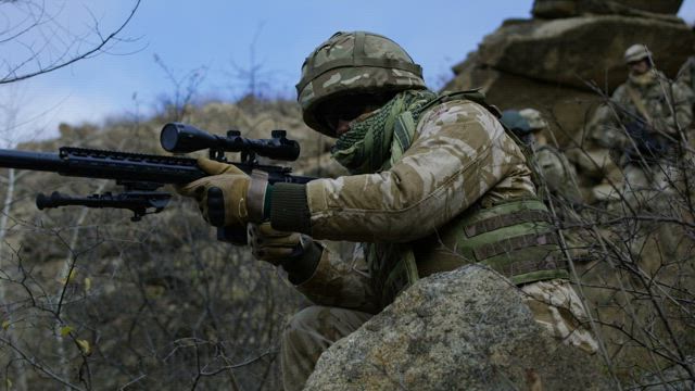 Sniper providing cover for patrol.