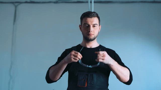 Man putting on protection and taking a saw.