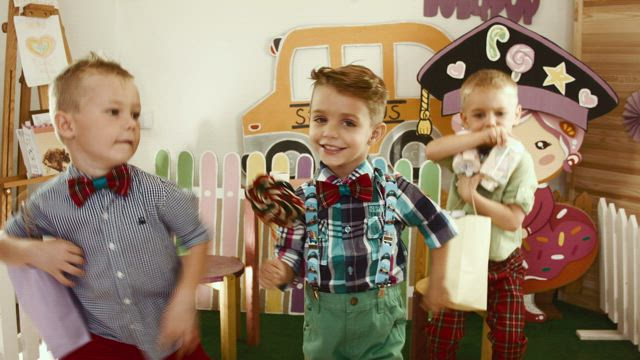 Three happy boys dancing.