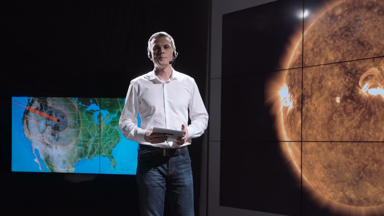 Weather newscaster presenting an eclipse - Free Stock Video