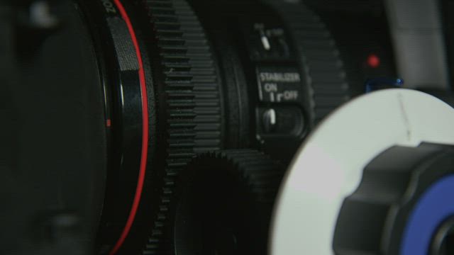 Adjusting a cinema camera.