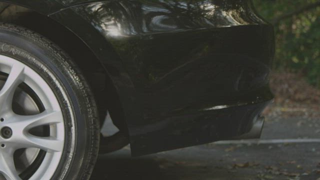 Side of a black car.