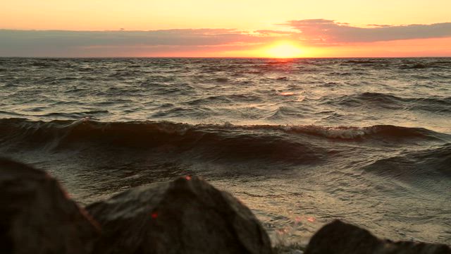 Deep waves and an orange sunset.