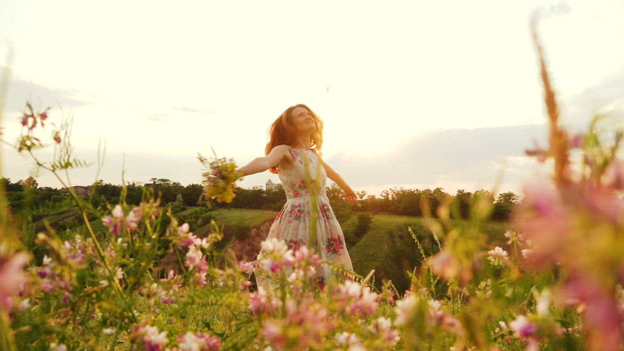 Woman with  bouquet spinning in the hill - Free Stock Video