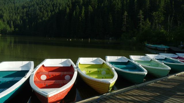 Multicolor boats in the lake pier.