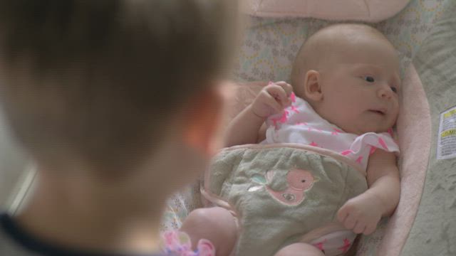 Brother with his newborn sister.