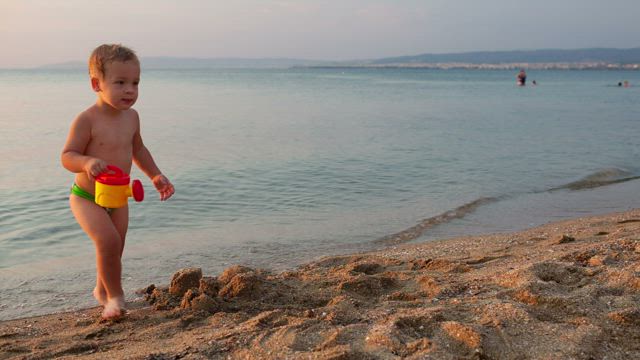 Boy playing at the seashore.
