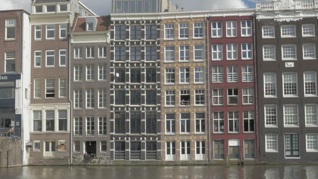 Tall houses along a river.
