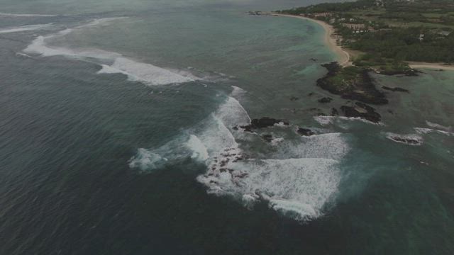 Waves breaking before reaching the beach.