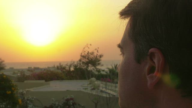 Man putting on glasses to look at the horizon.