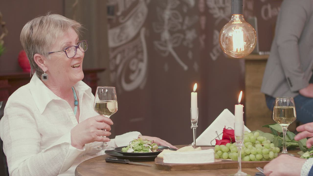 Woman holding a glass of white wine - Free Stock Video